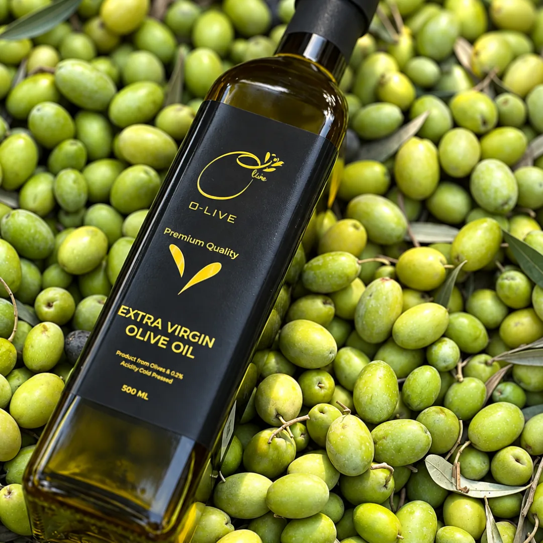 An O-Live bottle lying on freshly picked green olives